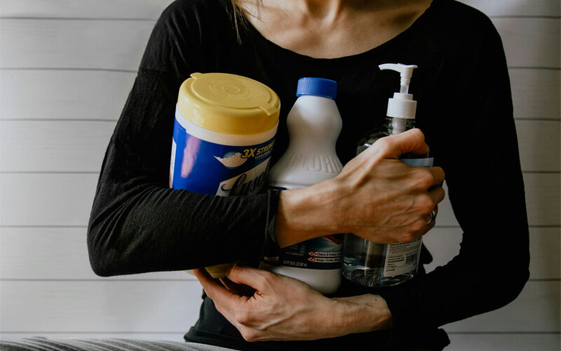 Woman holding household products